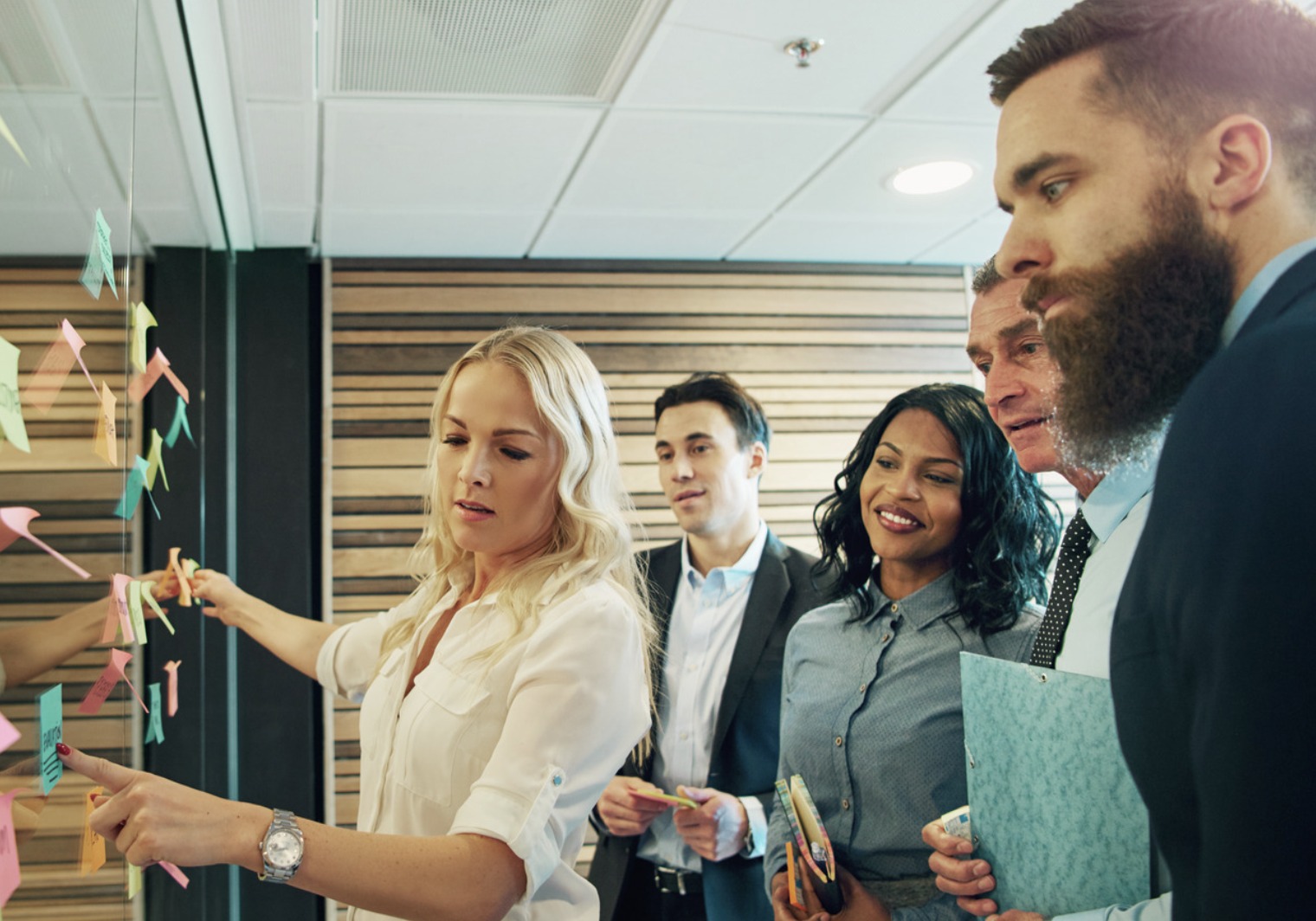 A leadership team working through ideas together at a wall